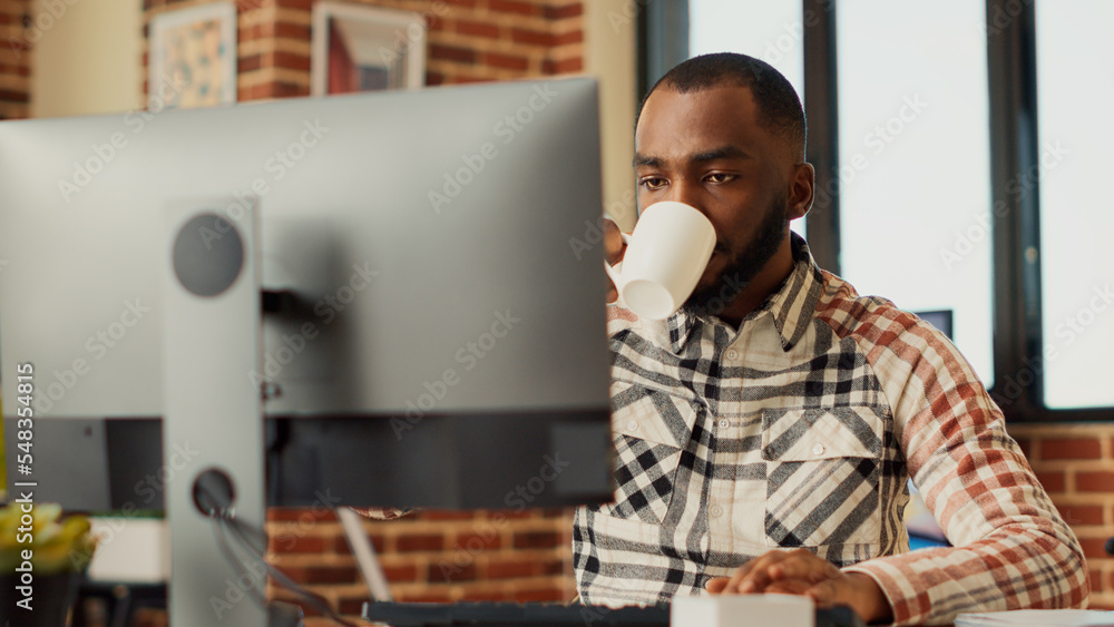 Poster male freelancer doing remote work at home to plan sales report, using computer and sending email to 