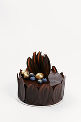 chocolate cake decorated with gold and berries