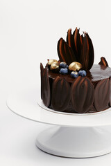 chocolate cake decorated with gold and berries