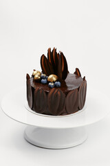 chocolate cake decorated with gold and berries