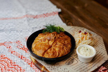 pie from the oven with cabbage and sauce