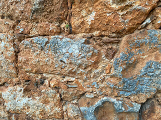 Background, texture, stone wall of round stones cobblestones bricks natural surface natural sharp convex rough stone cobblestone with cracks