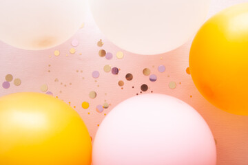 Celebration background with pink, gold and white air balloons, card with rosy copy space and glitter decoration