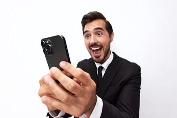 Business man himself on the phone taking a selfie with a smile with teeth happy communicating via video call online in a business suit on a white isolated background close-up on a wide angle lens