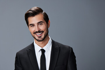 Portrait of a business man with a natural smile with teeth on a gray background in a business suit. Business portrait of a stylish man copy space
