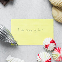 I am sorry written on a sticky note, handwritten apology on a yellow note