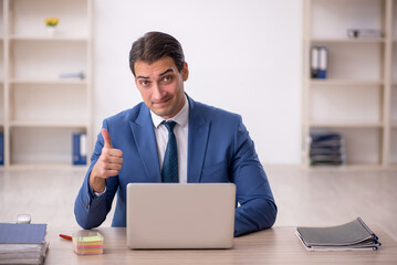 Young male employee working in the office