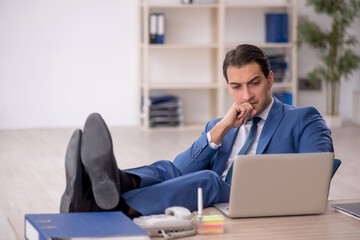 Young male employee working in the office