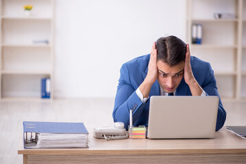 Young male employee working in the office
