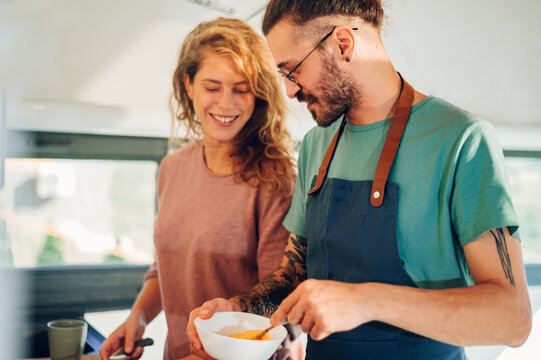 Young Couple Making Breakfast Together In The Kitchen At Home