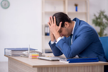 Young male employee working in the office