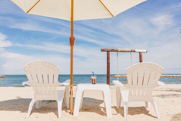 Beach bar cafe in white theme in bright sky and blue sea of tropical vacation.