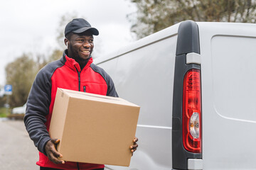 Package delivery concept. Outdoor medium closeup shot of middle-aged African-American handsome...