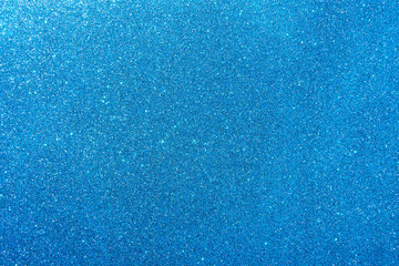 Background with sparkles. Backdrop with glitter. Shiny textured surface. Strong blue