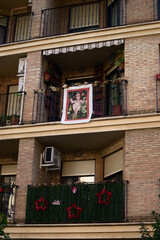 Fototapeta na wymiar Christmas decorations on the balconies of a building in a Spanish city