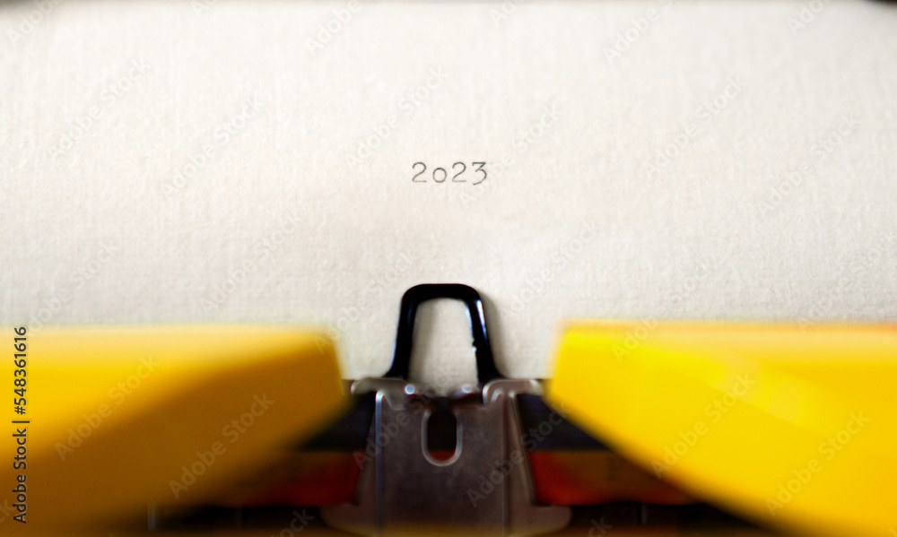 Poster old typewriter with following text on paper - 2023 chapter one. new years concept