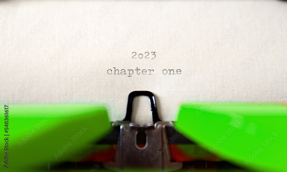 Poster old typewriter with following text on paper - 2023 chapter one. new years concept