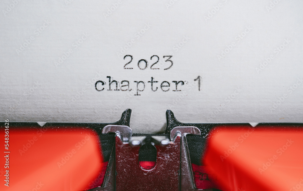 Poster old typewriter with following text on paper - 2023 chapter one. new years concept