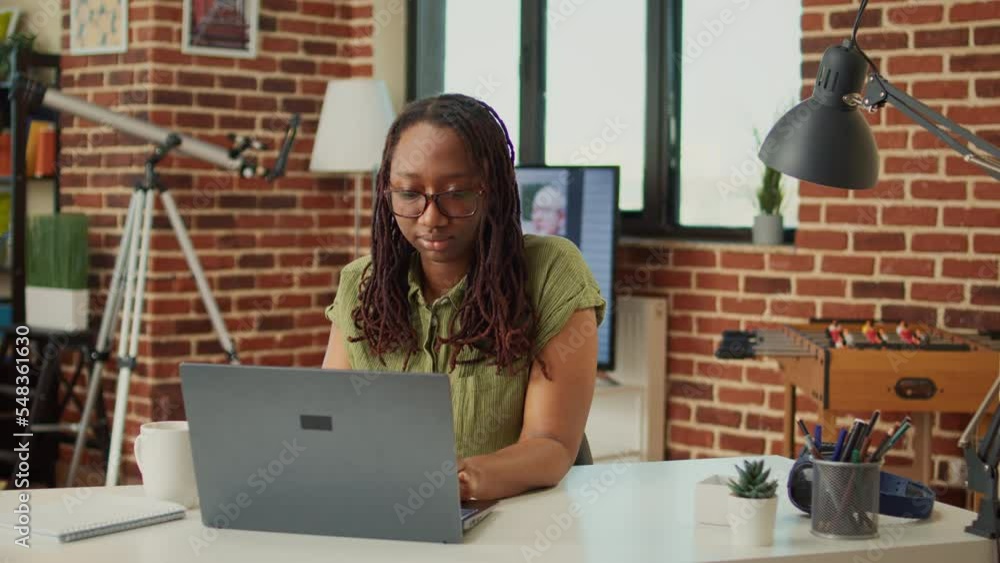Poster smiling worker browsing internet on laptop at home, working remote to analyze web information for on