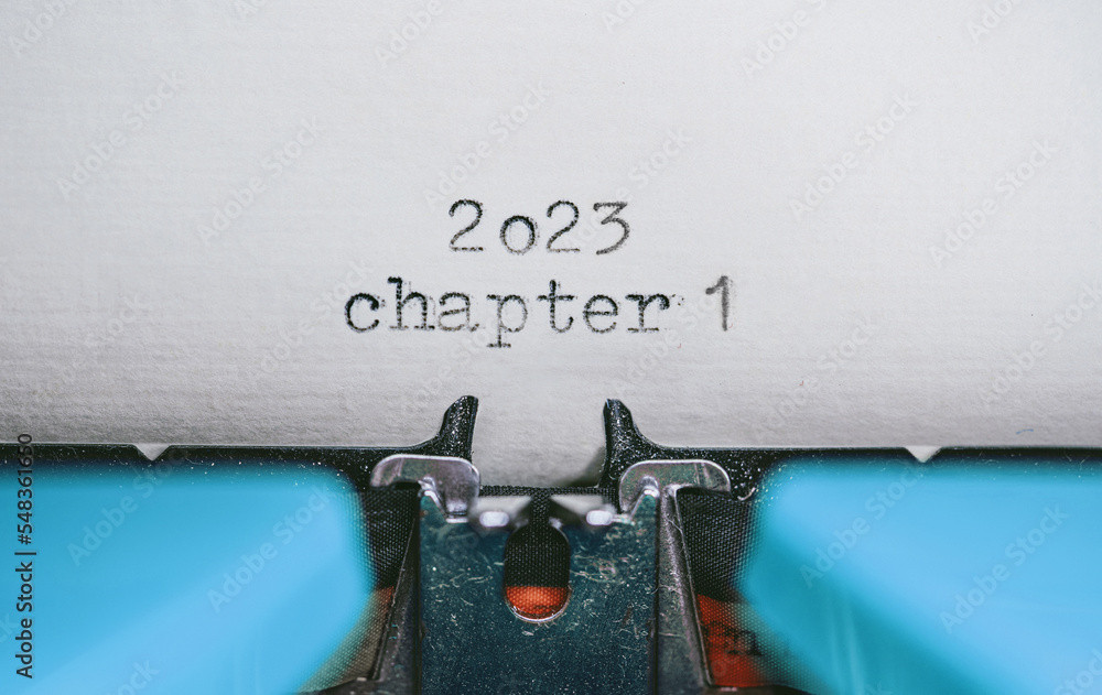 Poster old typewriter with following text on paper - 2023 chapter one. new years concept
