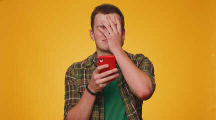 Teen man in shirt use mobile cell phone typing browsing, loses becoming surprised sudden lottery...