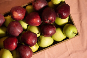 Top view red and yellow apples in the wooden box - red chief apples and golden apples.