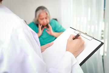 Obraz premium Doctors record treatment records for elderly patients sitting in wheelchairs. Internal Medicine Specialist Take care of the elderly. Hospital medical