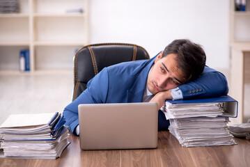 Young male employee working in the office