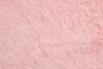 Soft pink towel as background, top view
