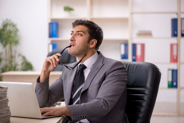 Young male employee working in the office