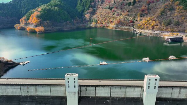 water dam and reservoir lake in the mountains, aerial view of hydropower electric power plant for renewable energy, sustainable hydroelectricity, water resources