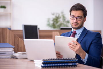 Young male employee working in the office