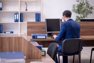 Young male employee working in the office