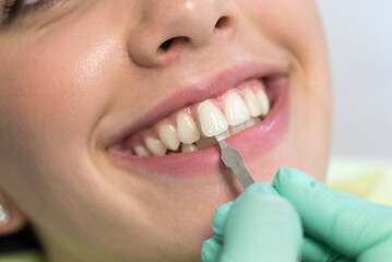 Fototapeta premium Young woman checking her teeth at the dentist clinic 