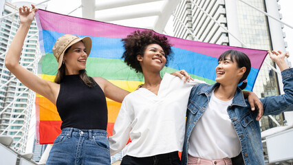 Group of young women activist for lgbt rights with rainbow flag, diverse people of gay and lesbian...