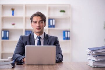 Young male employee working in the office