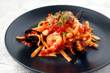 Freshly cooked seafood pasta in marinara sauce