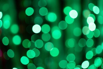 Defocused green light dots in dark night. Bokeh background