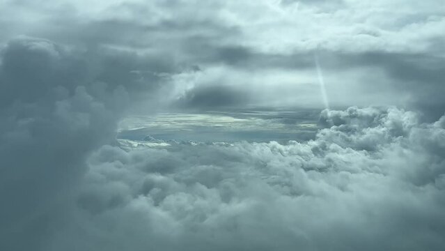 Pilot point of view from a jet cockpit flying through a gap in a turbulent winter sky. 4k