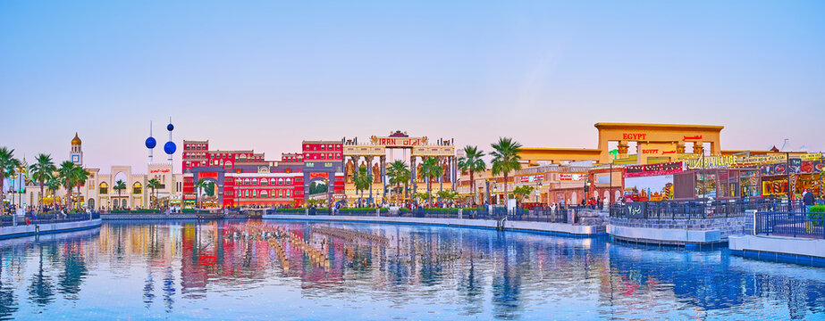 Panorama of pond and pavilions of Global Village Dubai at sunset, on March 6 in Dubai, UAE