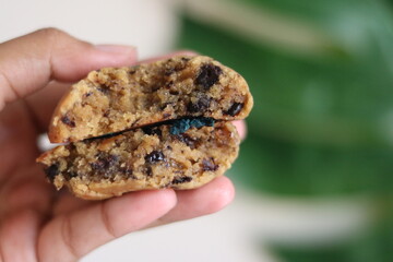 chocolate cake in hand on blurred background