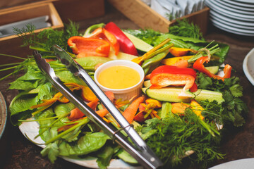 Beautifully decorated catering banquet table with variety of and different vegan vegetarian snacks, salads, vegetable sticks on corporate Christmas birthday party event or wedding celebration
