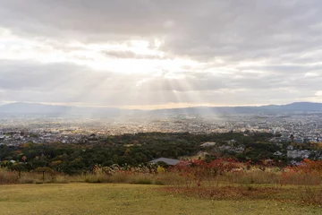 Foto op Canvas 若草山山頂からの奈良市内の眺めとの薄明光線（天使の梯子） © SP studio