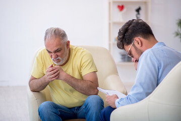 Old man visiting young male psychotherapist