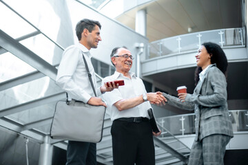business people meeting each other in the lobby of the business center.