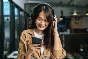 Foto op Plexiglas Young woman enjoy to listening music on headphone © Johnstocker