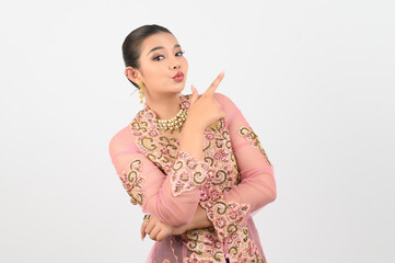 Obraz premium Young beautiful woman dress up in local culture in southern region point finger posture
