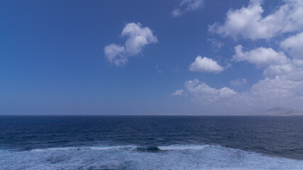 Naklejka na ściany i meble Atlantic ocean with many strong waves during sunny day with clear sky, Canary Islands
