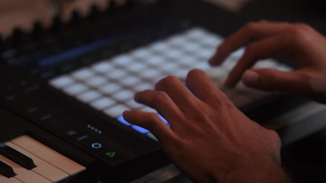 DJ is playing music on the AKAI MPK Music production hardware, Slow motion close up. Full HD