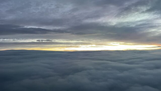 Aerial view while flying through a cold winter sky at dawn. Pilot point of view.